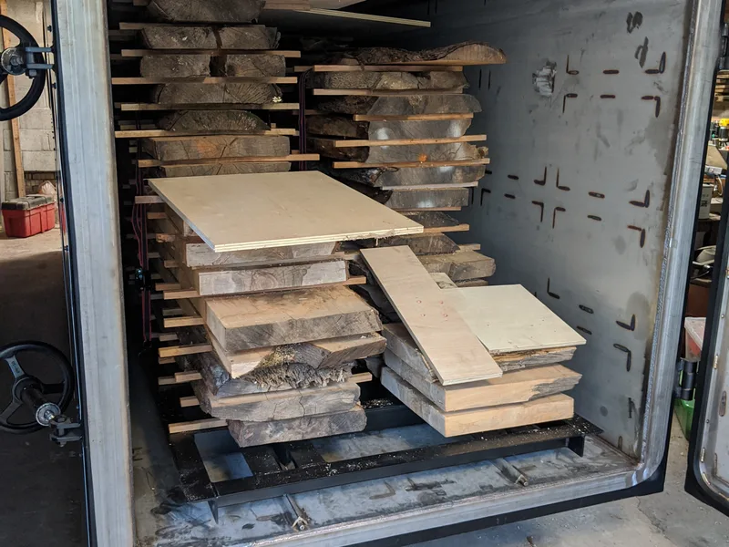 Inside Martin Woodworking's iDry vacuum kiln, loaded with racks of hardwood slabs