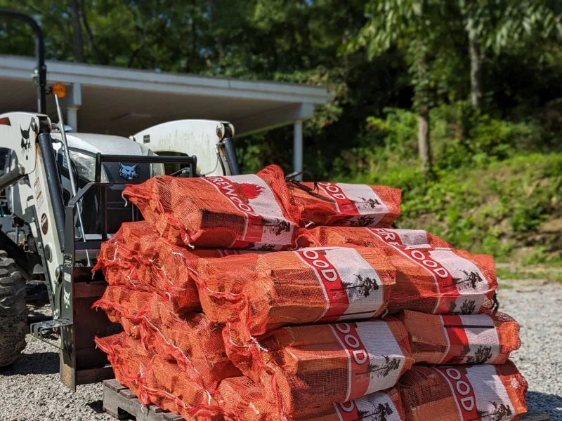 Bagged firewood bundles staged on a loader, ready for pickup