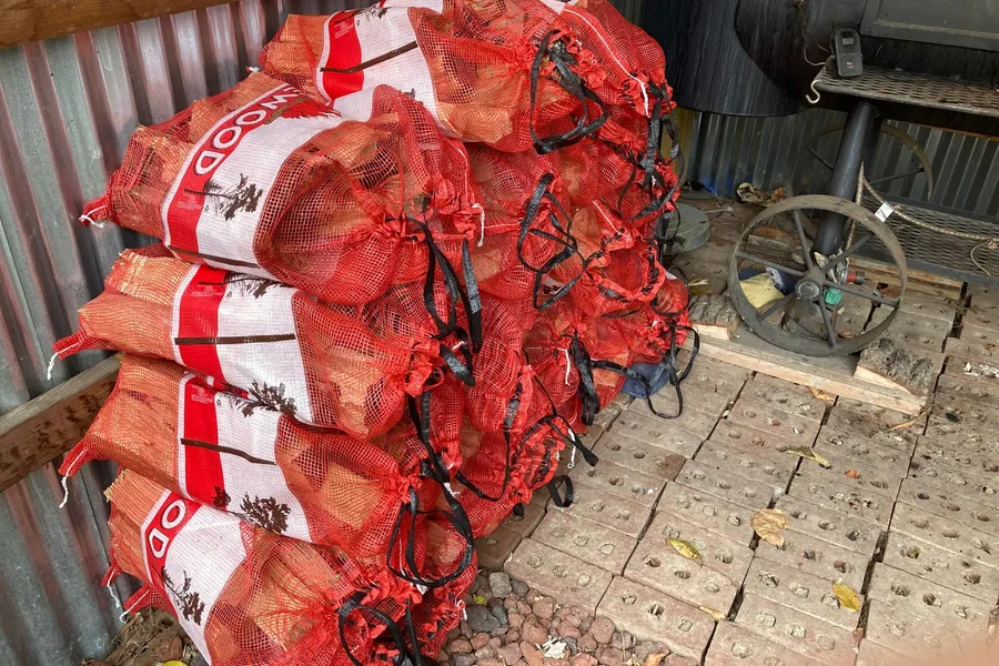 Bundled, kiln-dried firewood bagged and staged for pickup